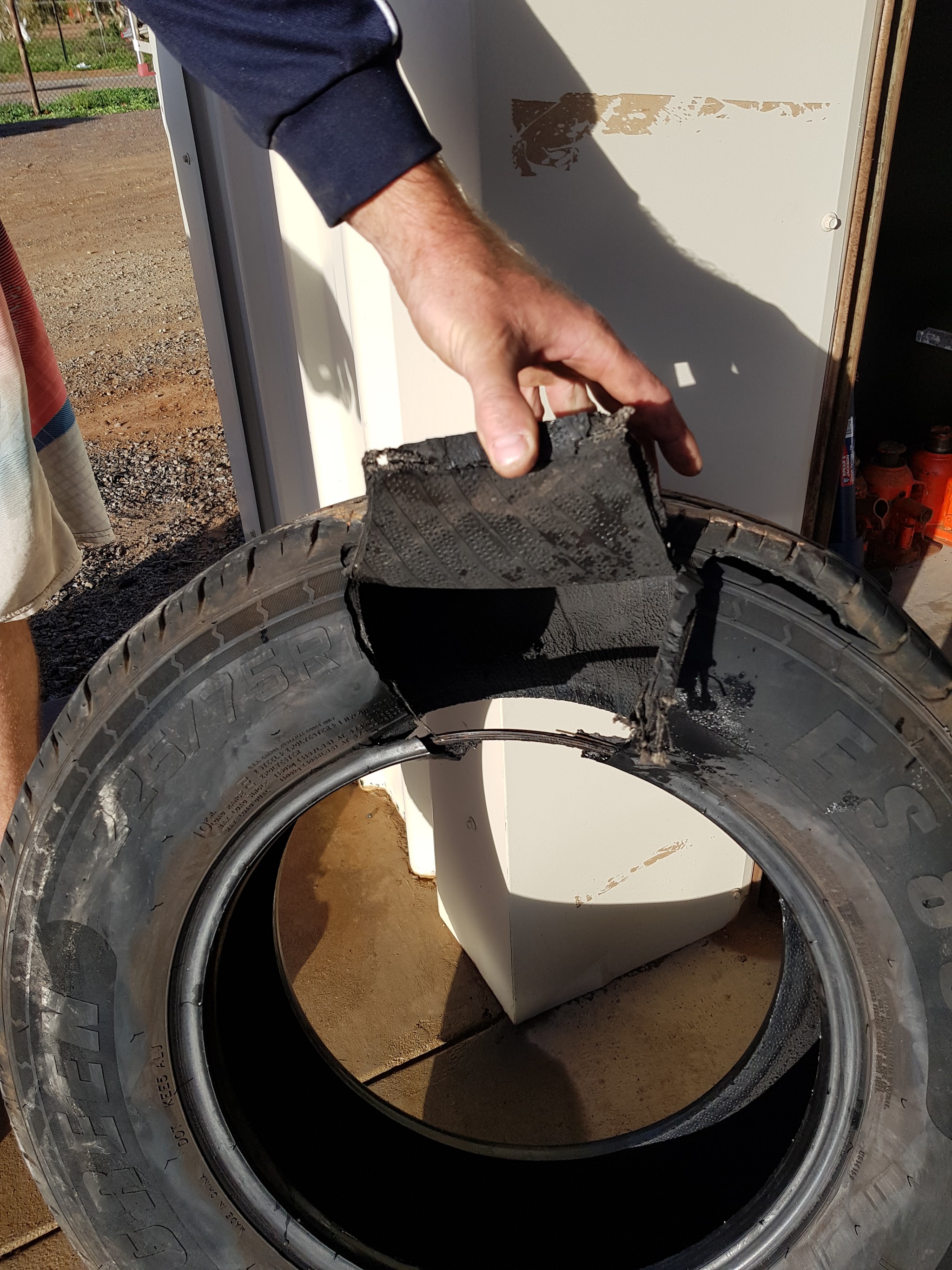 The blown truck tyre laid out on the gravel of the Cornish Street yard